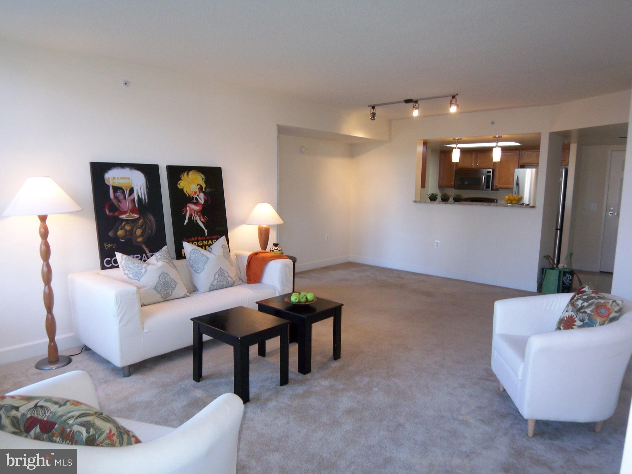 11800 Sunset Hills Road, Unit 608 Reston, VA 20190 - Photo 12 of 15 a living room with furniture and a flat screen tv