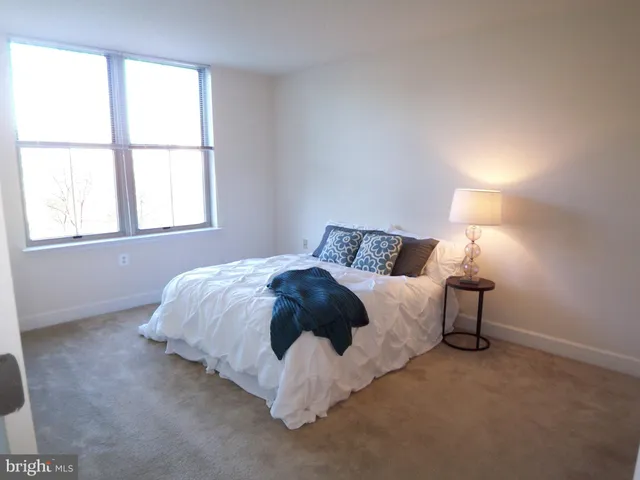 a bedroom with a bed and a night stand