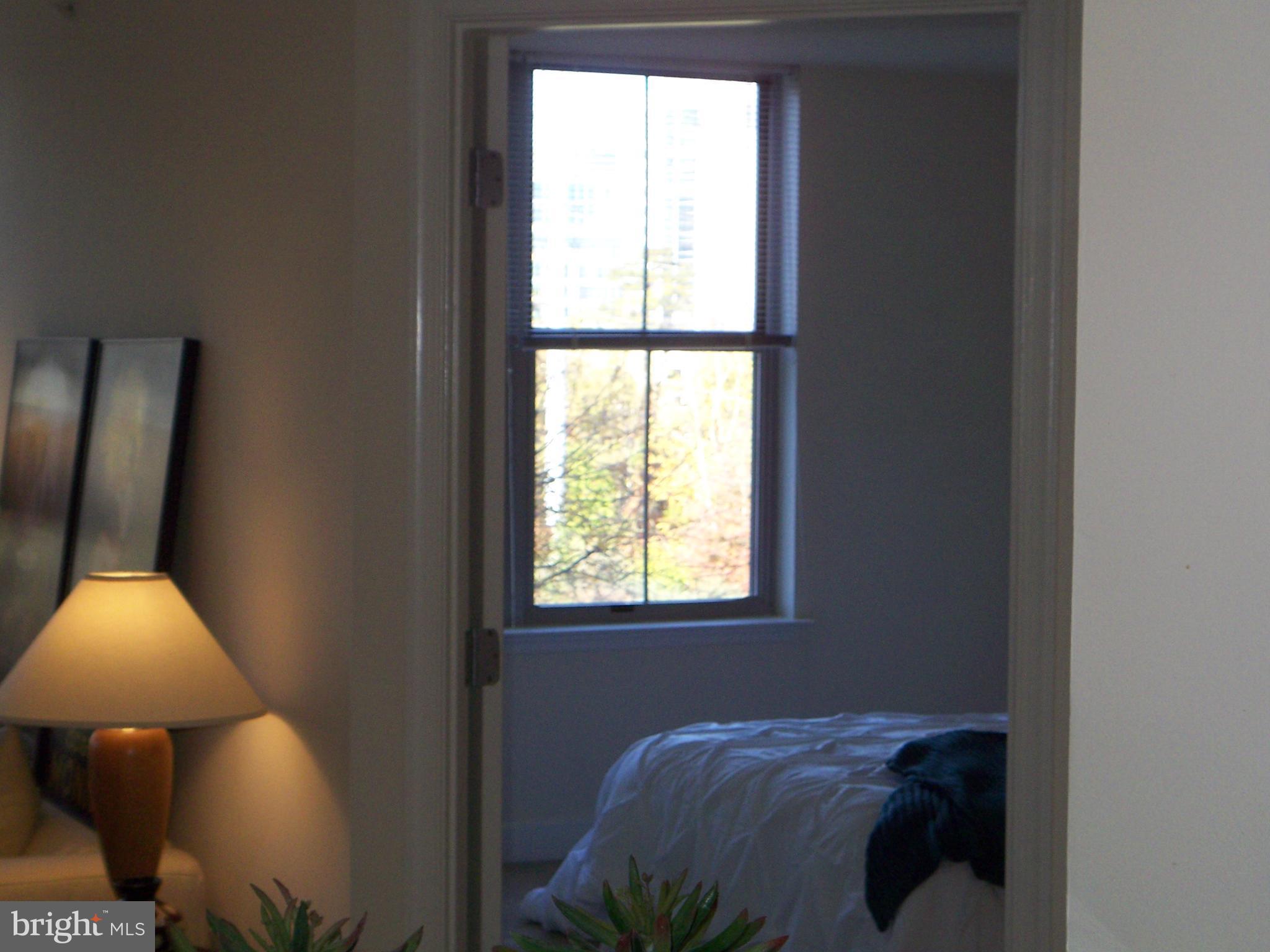 11800 Sunset Hills Road, Unit 608 Reston, VA 20190 - Photo 15 of 15 a bed sitting in a bedroom next to a window