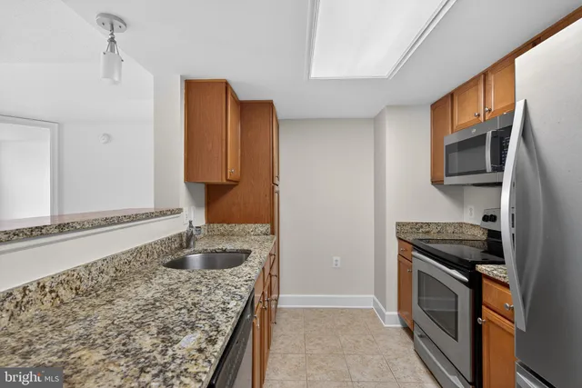 a kitchen with stainless steel appliances granite countertop a stove and a microwave