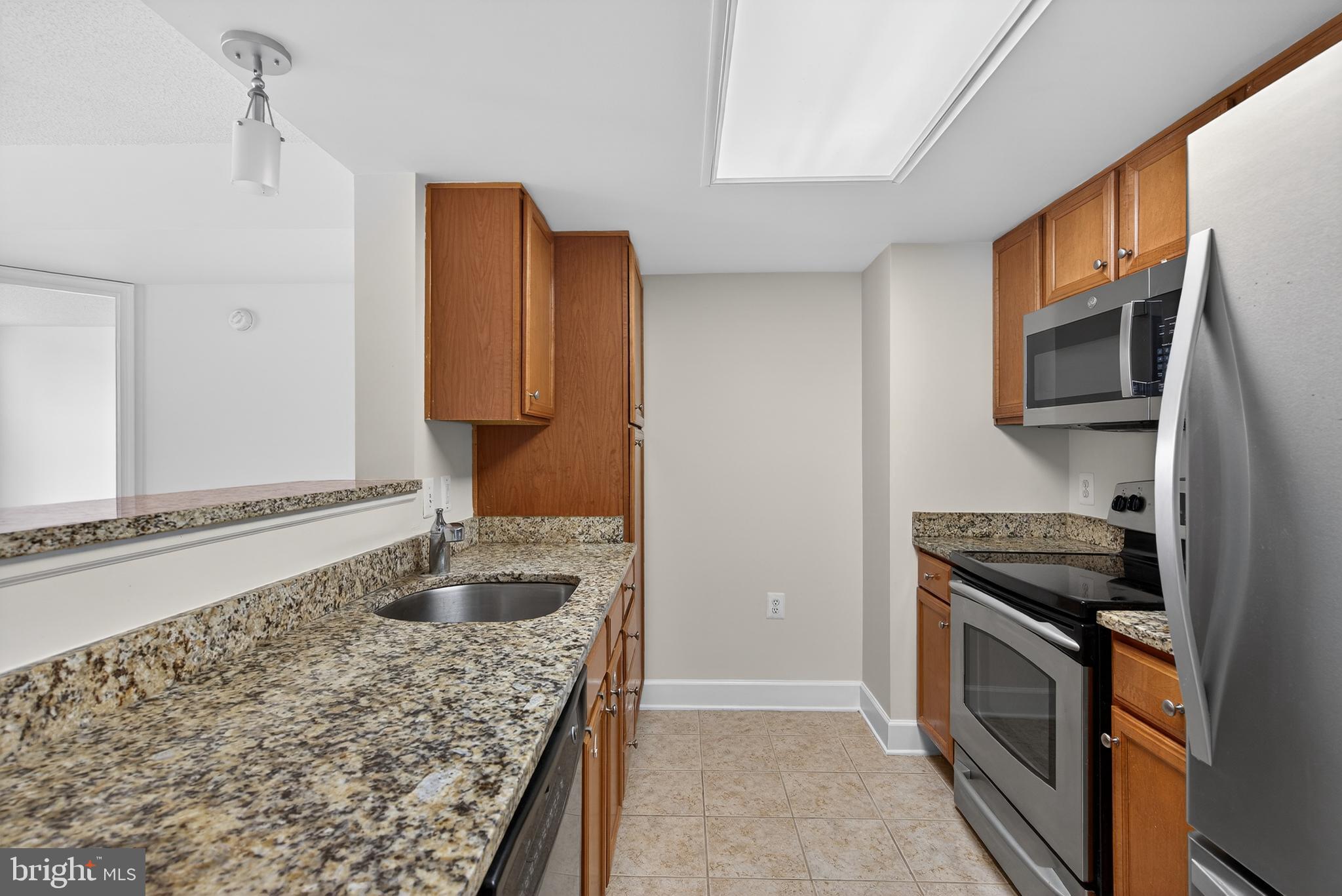 11800 Sunset Hills Road, Unit 608 Reston, VA 20190 - Photo 21 of 40 a kitchen with stainless steel appliances granite countertop a stove and a microwave