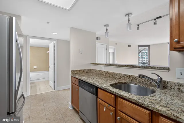 a kitchen with a sink granite counter top and a sink