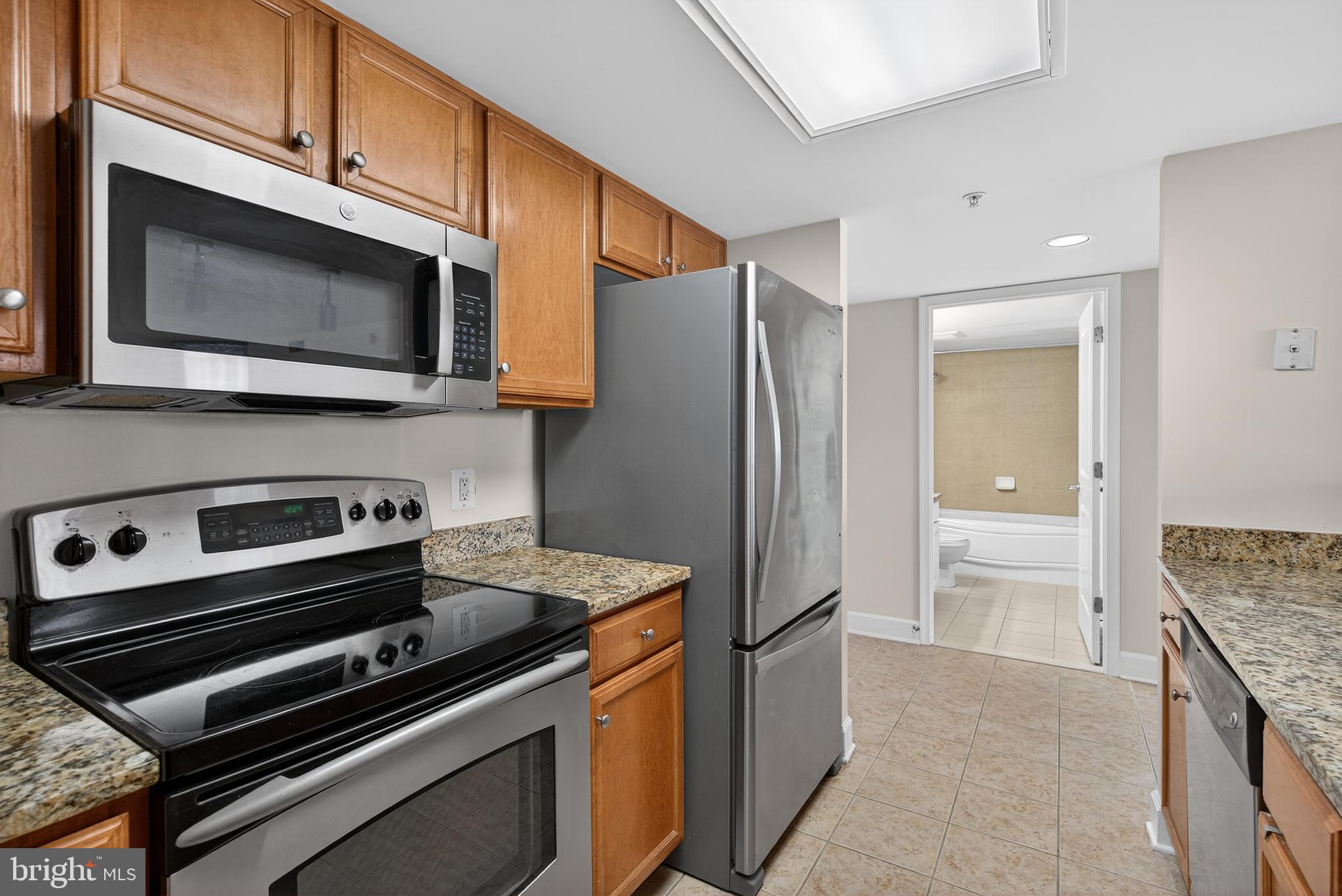 11800 Sunset Hills Road, Unit 608 Reston, VA 20190 - Photo 23 of 40 a kitchen with granite countertop cabinets and steel stainless steel appliances