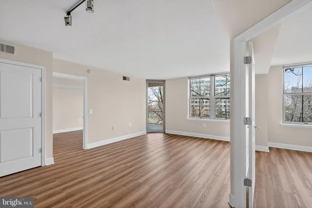 wooden floor in an empty room with a window