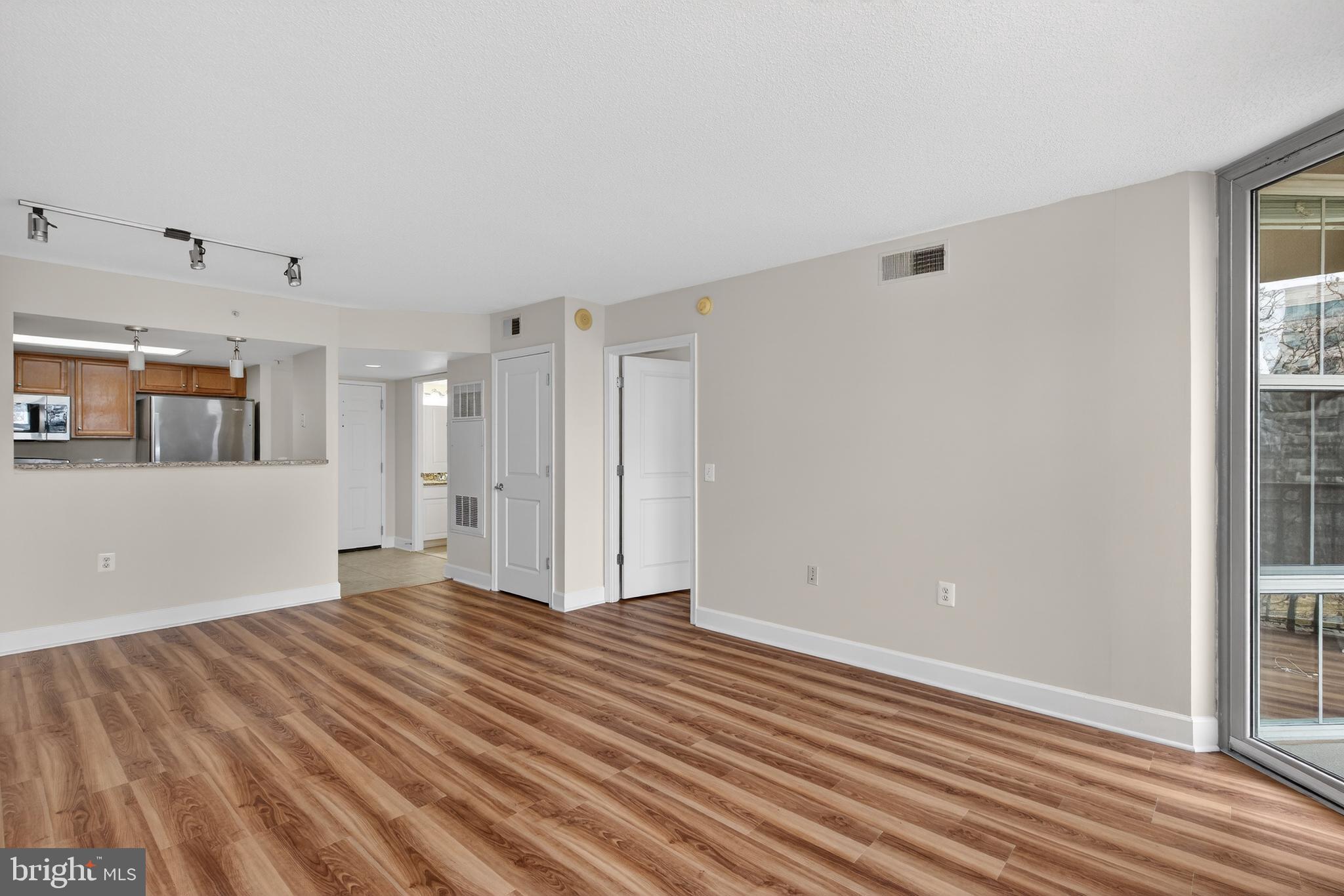 11800 Sunset Hills Road, Unit 608 Reston, VA 20190 - Photo 26 of 40 a view of an empty room with wooden floor and a window