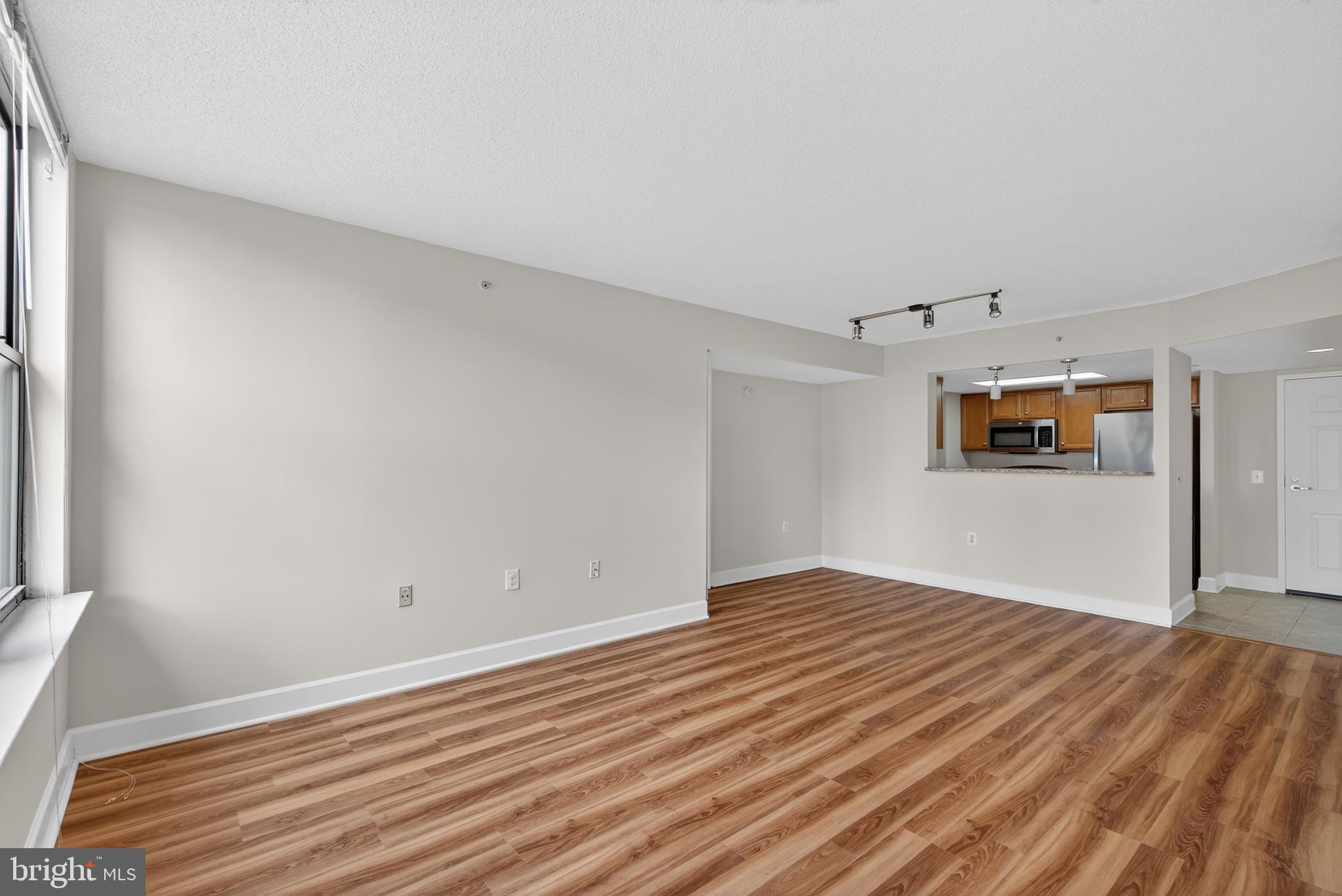 11800 Sunset Hills Road, Unit 608 Reston, VA 20190 - Photo 27 of 40 a view of a big room with wooden floor and windows