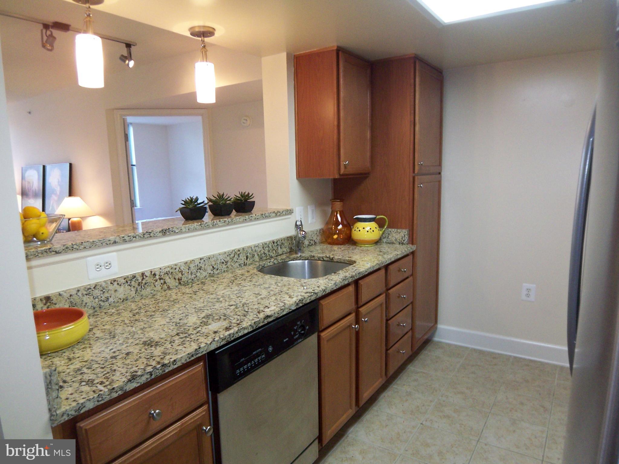 11800 Sunset Hills Road, Unit 608 Reston, VA 20190 - Photo 3 of 15 a bathroom with a granite countertop sink and a mirror