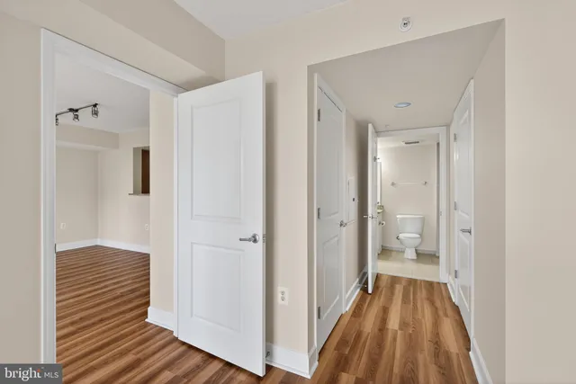 a bathroom with a granite countertop sink a toilet and shower
