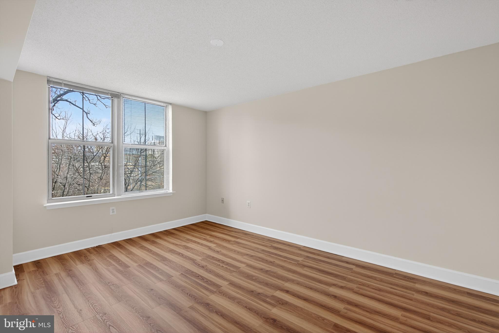11800 Sunset Hills Road, Unit 608 Reston, VA 20190 - Photo 34 of 40 a view of an empty room with wooden floor and a window