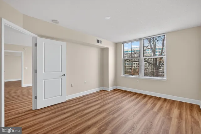 a bathroom with a granite countertop sink a toilet and a mirror