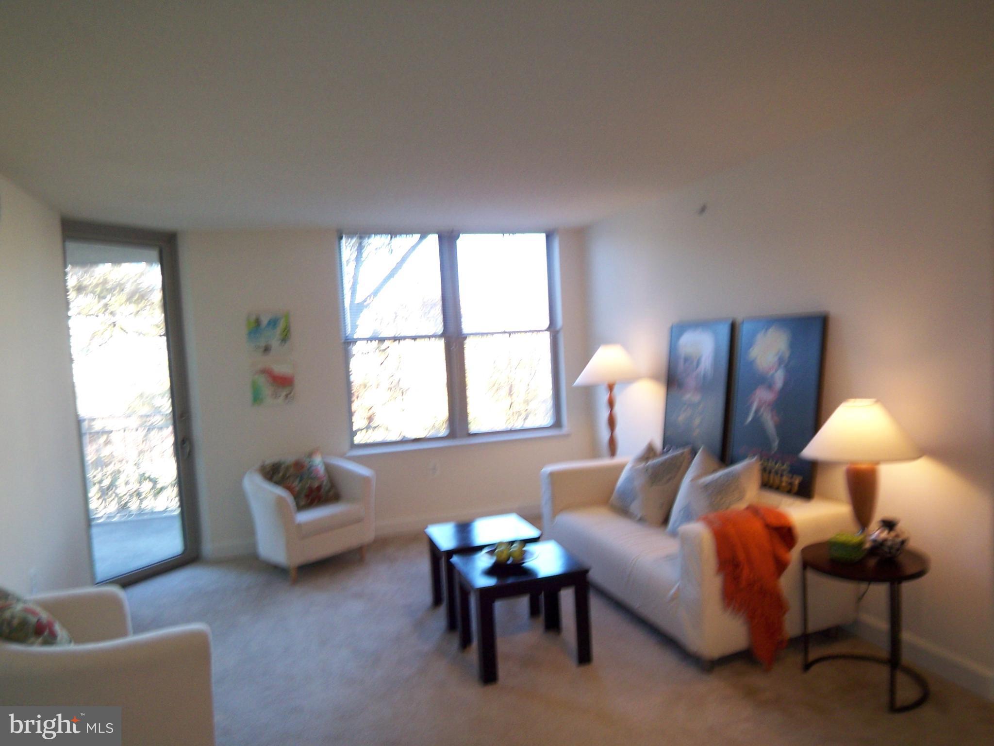 11800 Sunset Hills Road, Unit 608 Reston, VA 20190 - Photo 6 of 15 a living room with furniture and a lamp