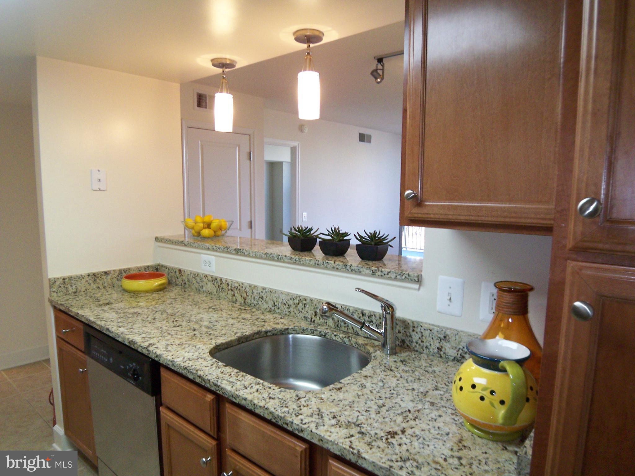 11800 Sunset Hills Road, Unit 608 Reston, VA 20190 - Photo 7 of 15 a bathroom with a granite countertop sink and a mirror