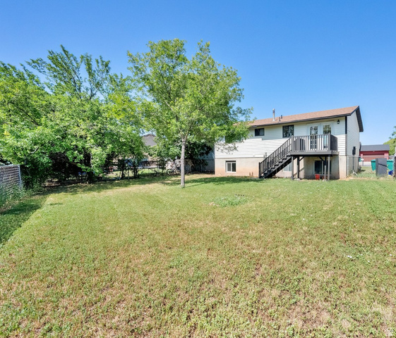 282 East 925 South Layton, UT 84041 - Photo 1 of 1 Fenced backyard with stairs and a wooden deck