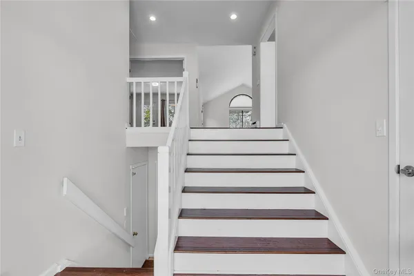 an empty room with wooden floor & door