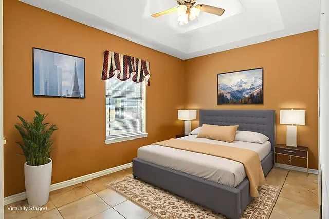 a bedroom with a bed and a potted plant