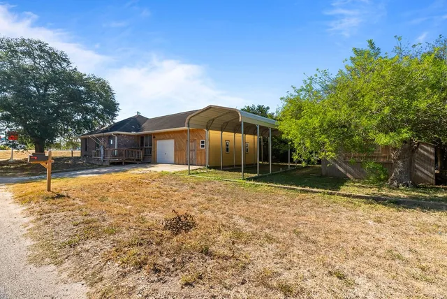 a backyard of a house with large trees