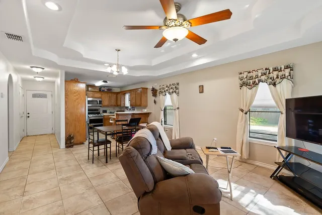 a view of a livingroom with workspace and a window