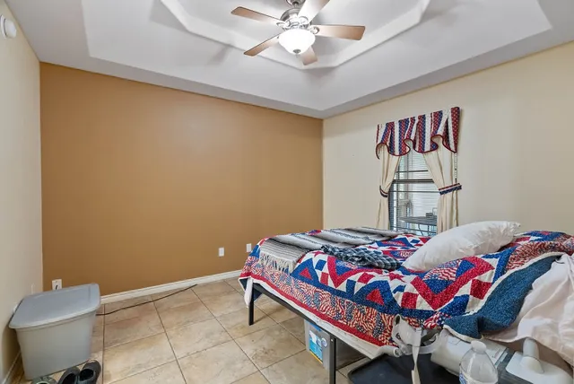 a bedroom with a bed and a chandelier