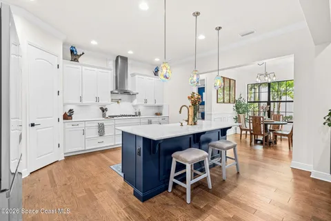 a view of kitchen with kitchen island and stainless steel appliances