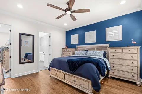 a view of bedroom with furniture and a ceiling fan