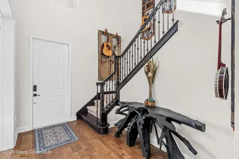 a view of entryway with wooden floor and stairs