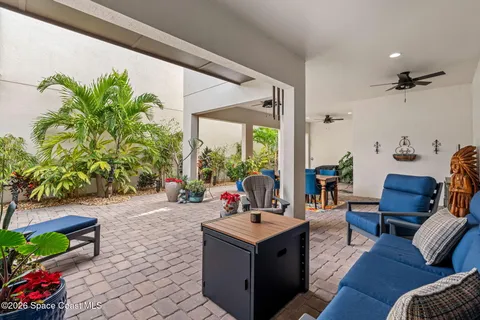 a view of a patio with couches and potted plants