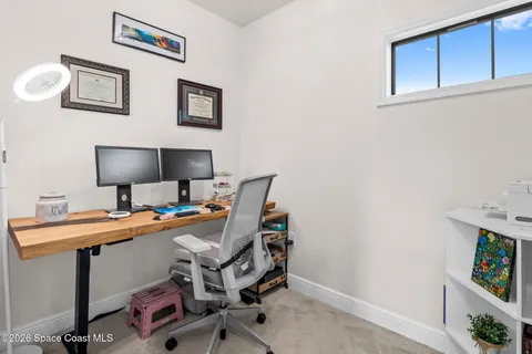 a view of a workspace with furniture and a lamp