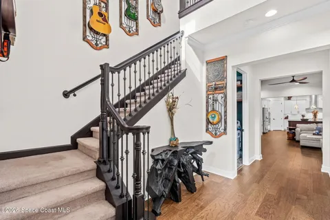a view of entryway and hall with wooden floor