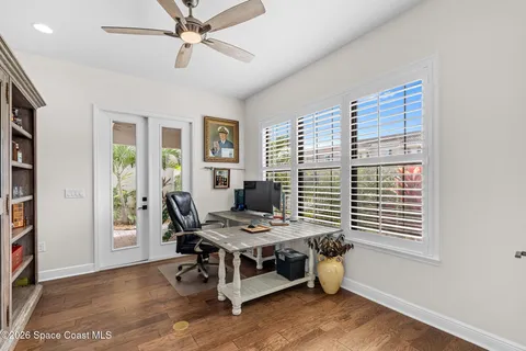 a view of a workspace with furniture and a window