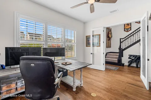 a workspace with furniture hardwood and a window