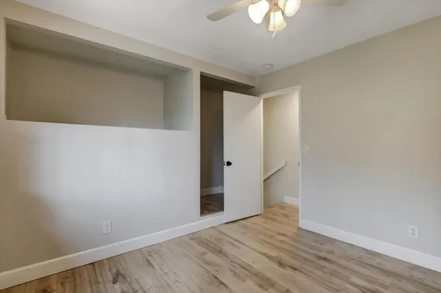 a view of a house with a yard balcony and large tree