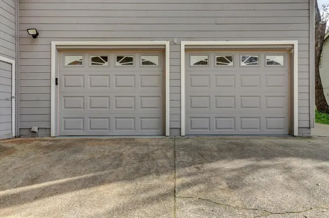 an aerial view of residential houses with outdoor space and lake view