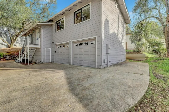 an aerial view of a house with a yard