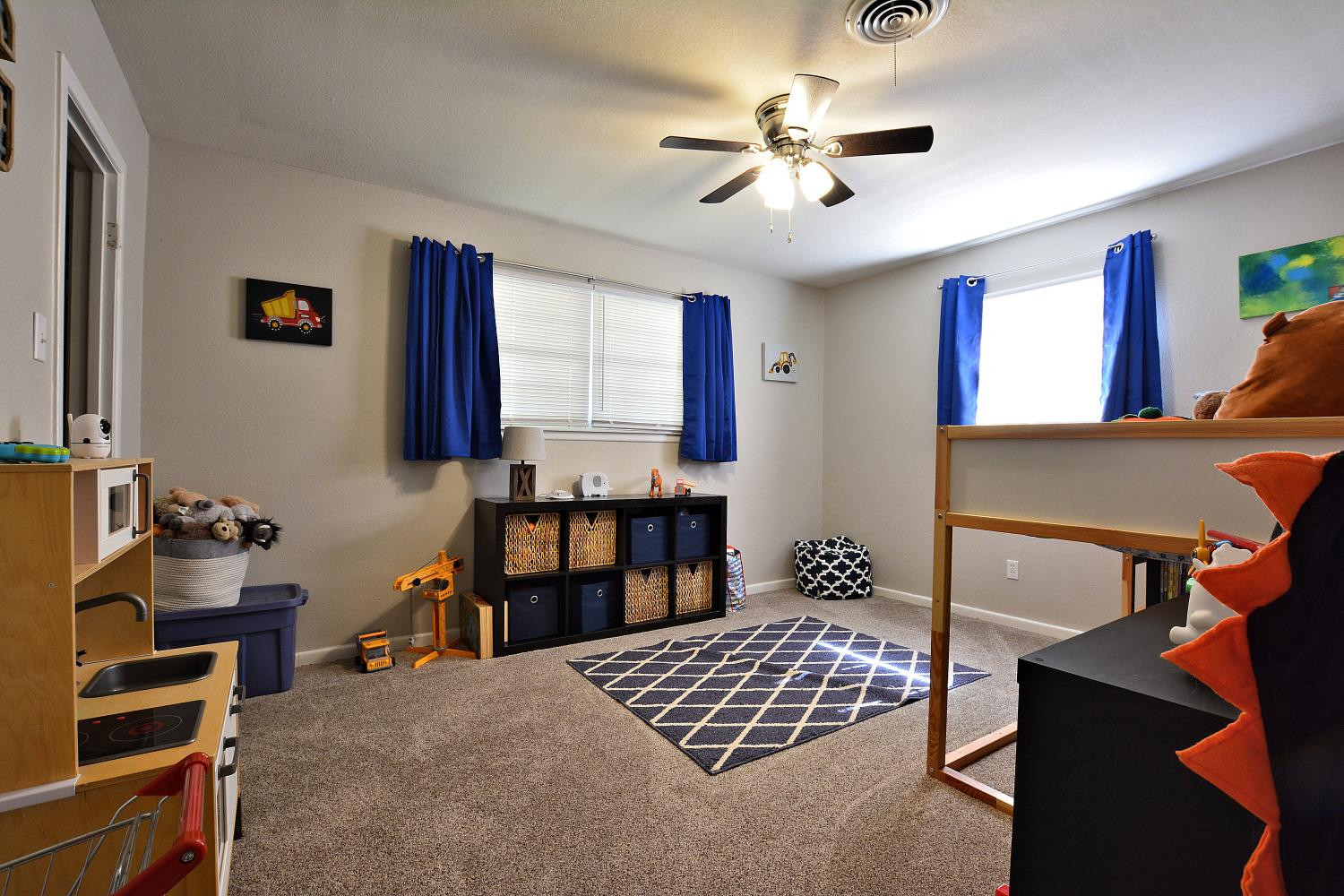 4903 17th Street Lubbock, TX 79416 - Photo 20 of 25 a bedroom with a bed cabinets and window