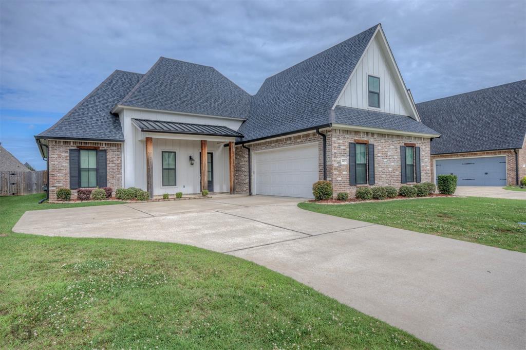 605 Meridian Way Benton, LA 71006 - Photo 1 of 29 Brick facade residence featuring a two-car garage, white siding, and dark-shingle roofing