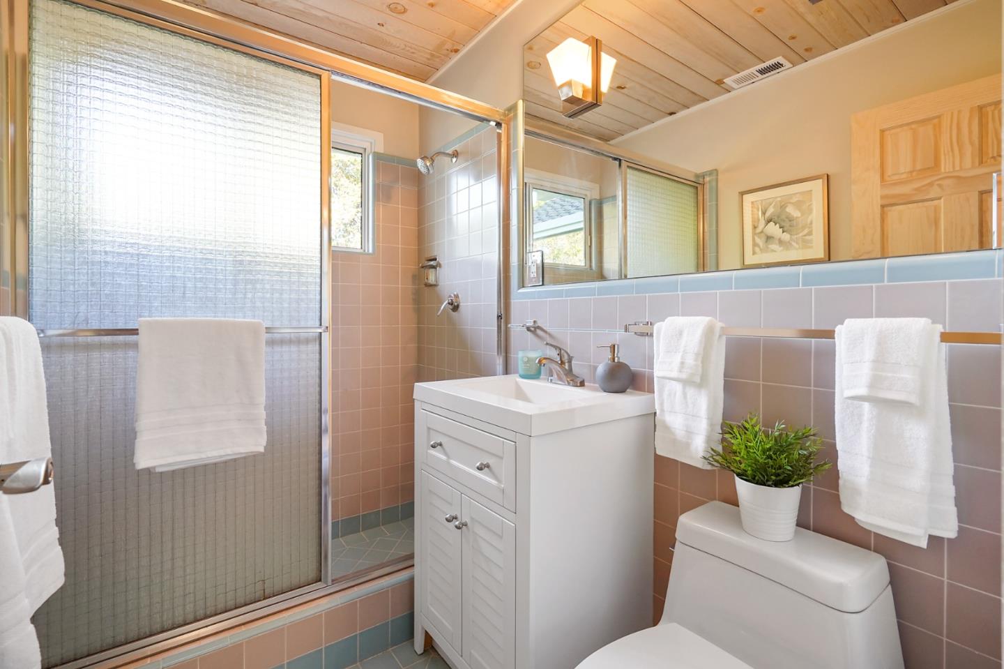 1183 Millbrae Avenue Millbrae, CA 94030 - Photo 44 of 98 a bathroom with a sink a mirror a toilet and shower