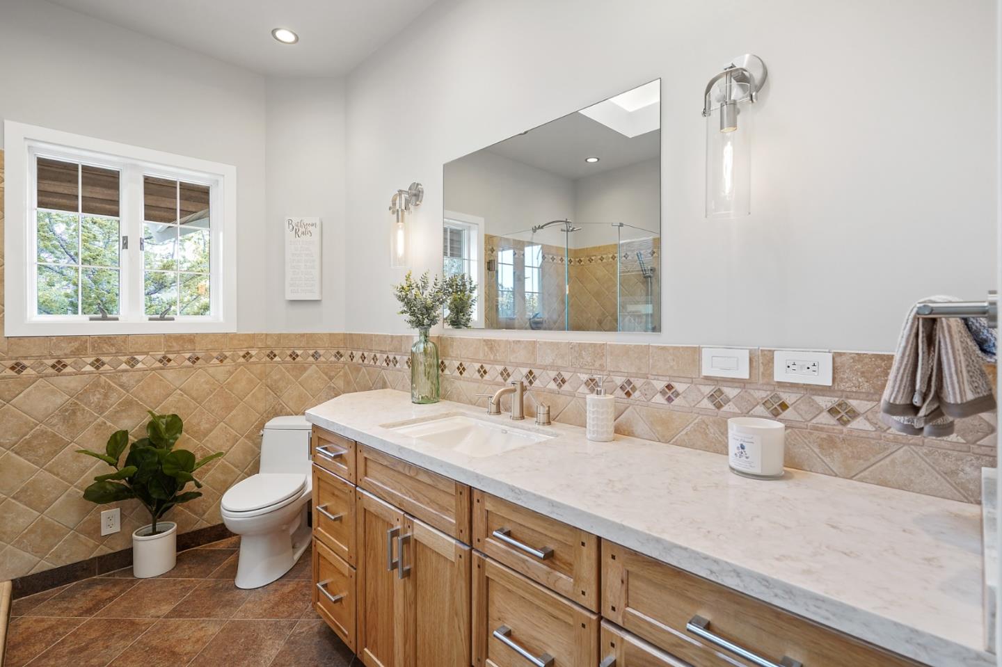 1183 Millbrae Avenue Millbrae, CA 94030 - Photo 60 of 98 a bathroom with a double vanity sink toilet and a mirror