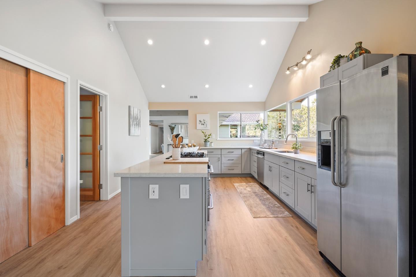 1183 Millbrae Avenue Millbrae, CA 94030 - Photo 9 of 98 a kitchen with stainless steel appliances granite countertop a refrigerator a sink dishwasher a stove and a dining table with wooden floor