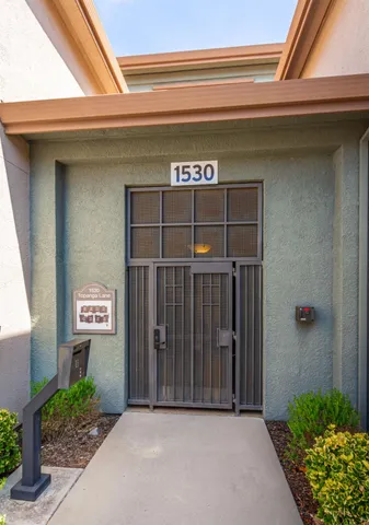 a view of a pathway with house and garden
