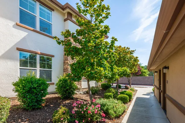 a view of a building with sitting area and furniture