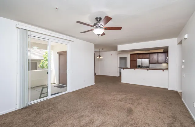 a view of a big room with wooden floor and a ceiling fan