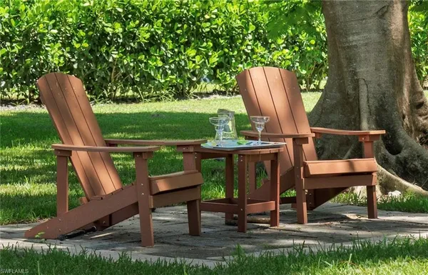 a view of a chairs and table in the backyard