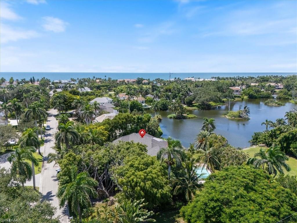 Undisclosed Address Naples, FL 34102 - Photo 2 of 22 an aerial view of lake and residential houses with outdoor space