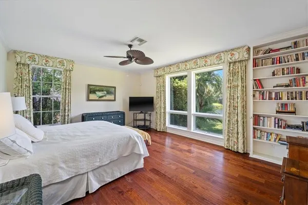 a bedroom with a large bed and a large window
