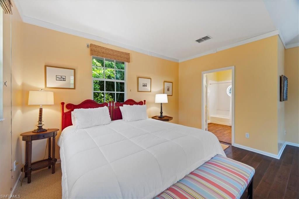Undisclosed Address Naples, FL 34102 - Photo 9 of 22 a bedroom with a bed and wooden floor