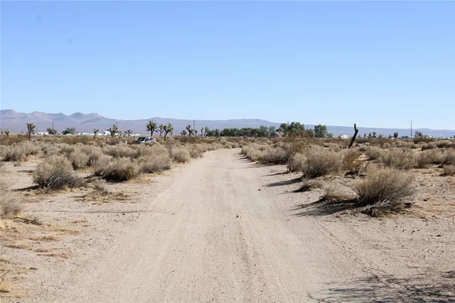 a view of a large mountain with a snow in the background