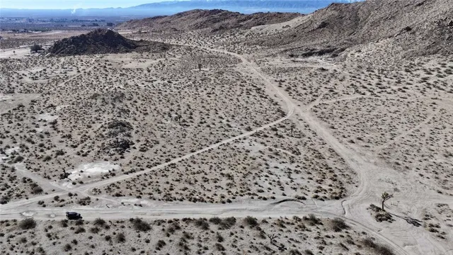 a view of a dry yard with mountains