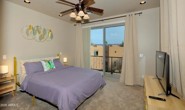 a bedroom with a large bed and a chandelier