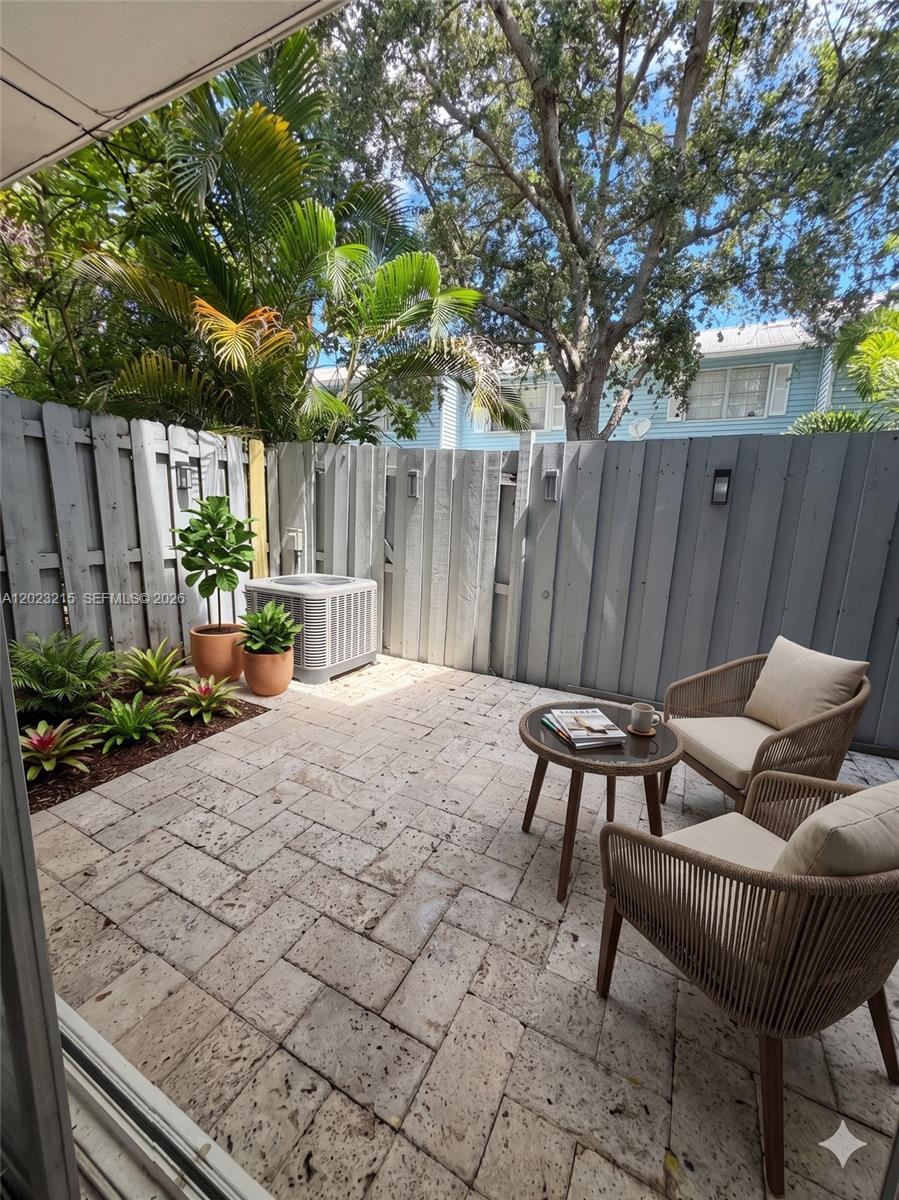 13 Southwest 3rd Street, Unit 13 Pompano Beach, FL 33060 - Photo 14 of 44 a backyard of a house with table and chairs