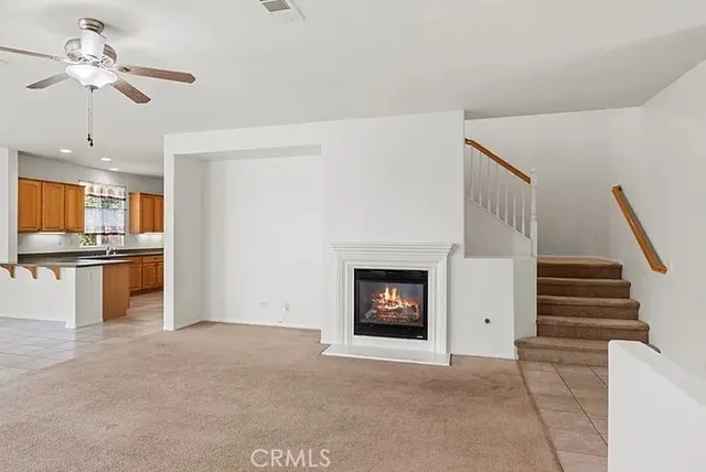 a view of kitchen with fireplace and cabinets